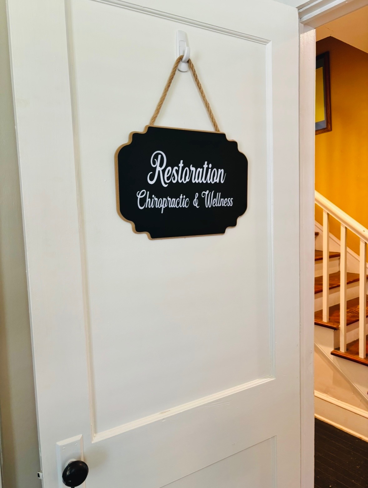 Restoration Chiropractic & Wellness office sign on a white door