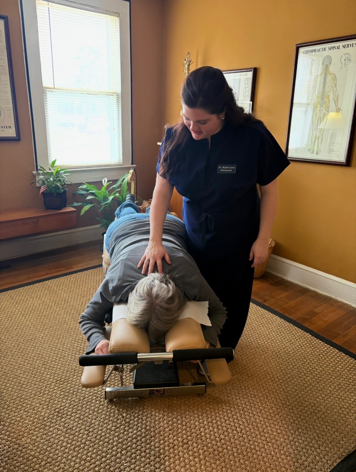 Dr. Skylar Lowe performing a chiropractic adjustment on an adult patient in the Griffin, Georgia office